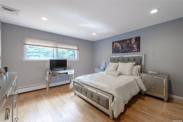 bedroom featuring light hardwood / wood-style floors and a baseboard radiator