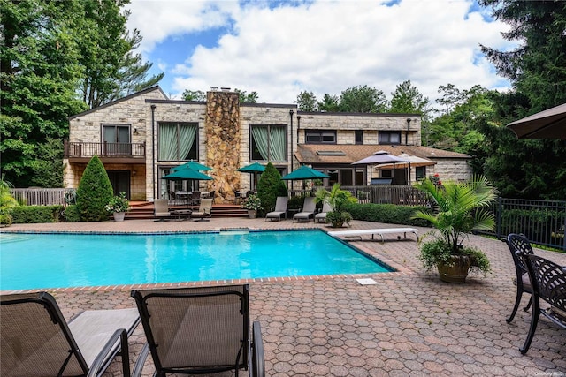 view of swimming pool featuring a patio