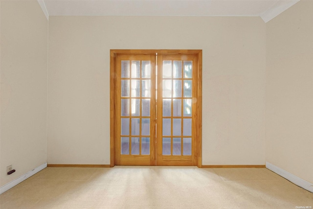 carpeted spare room featuring french doors