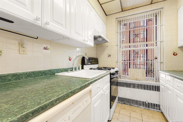 kitchen featuring white cabinetry, sink, light tile patterned floors, and gas range gas stove