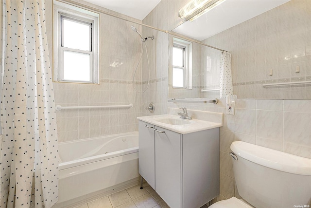 full bathroom featuring tile patterned flooring, shower / bath combo, a healthy amount of sunlight, and tile walls