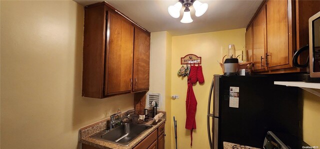 kitchen featuring black fridge and sink