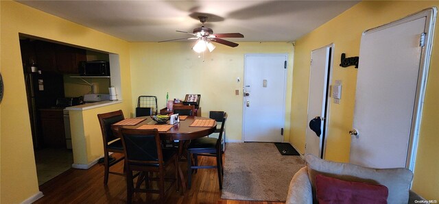 dining area featuring dark hardwood / wood-style flooring and ceiling fan