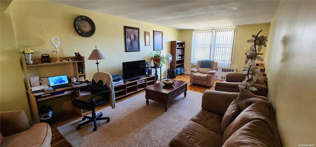 living room featuring radiator heating unit and hardwood / wood-style flooring