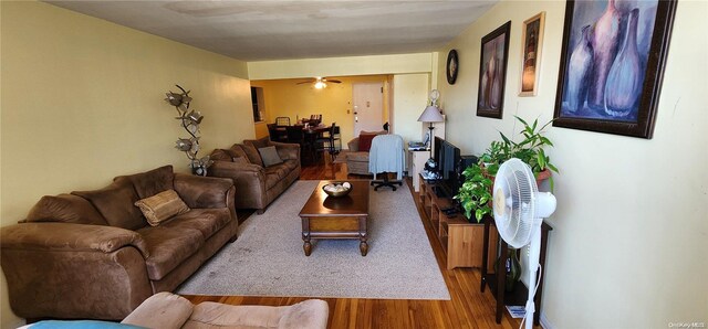 living room featuring hardwood / wood-style floors and ceiling fan