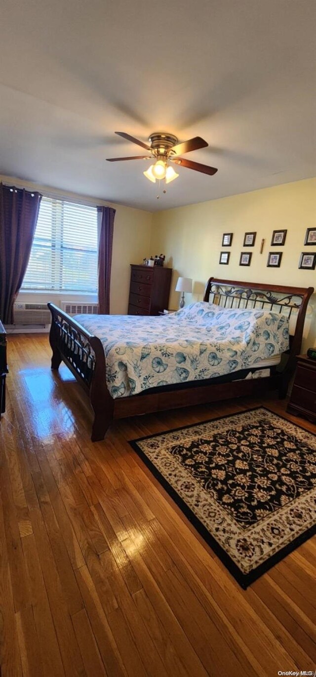 bedroom featuring hardwood / wood-style flooring and ceiling fan