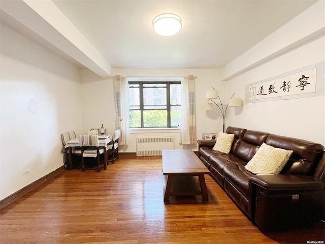 living room featuring hardwood / wood-style floors and radiator heating unit