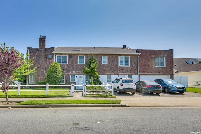 215 Roosevelt Blvd, Long Beach, NY 11561 - townhome / multi-family property featuring driveway, a chimney, brick siding, and a garage