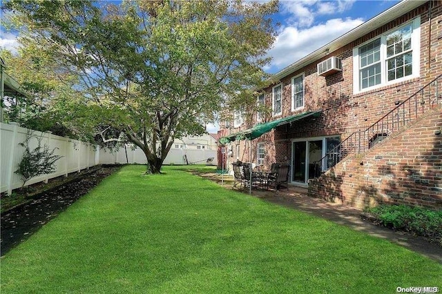 view of yard with a wall unit AC