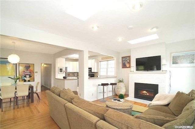 living room with a fireplace and light hardwood / wood-style flooring