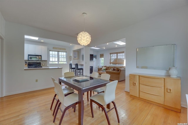 dining room featuring light hardwood / wood-style floors and a fireplace