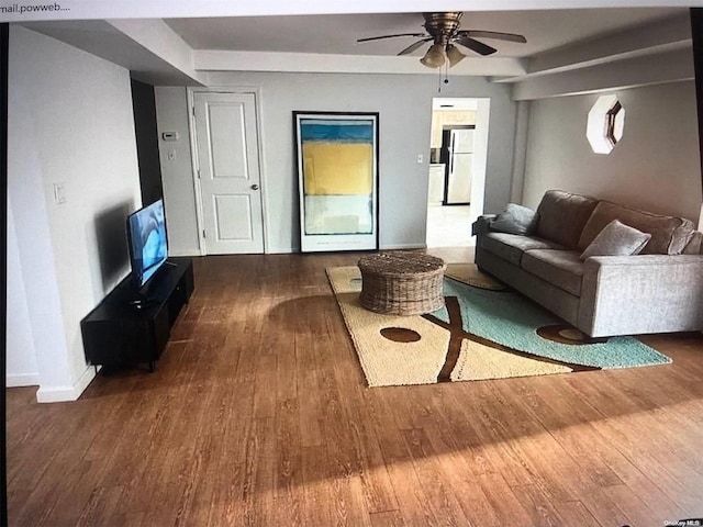 living room with ceiling fan and dark hardwood / wood-style flooring