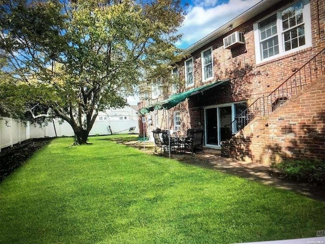 view of yard featuring a wall mounted air conditioner