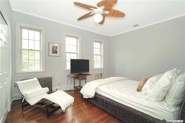 215 Roosevelt Blvd, Long Beach, NY 11561 - bedroom with multiple windows, wood finished floors, ornamental molding, baseboards, and radiator heating unit