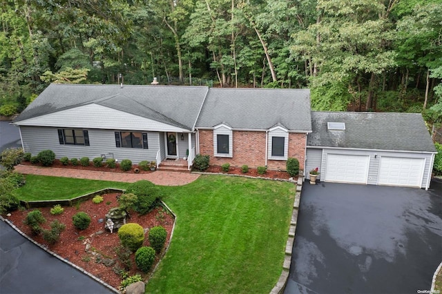 view of front of property featuring a garage and a front lawn