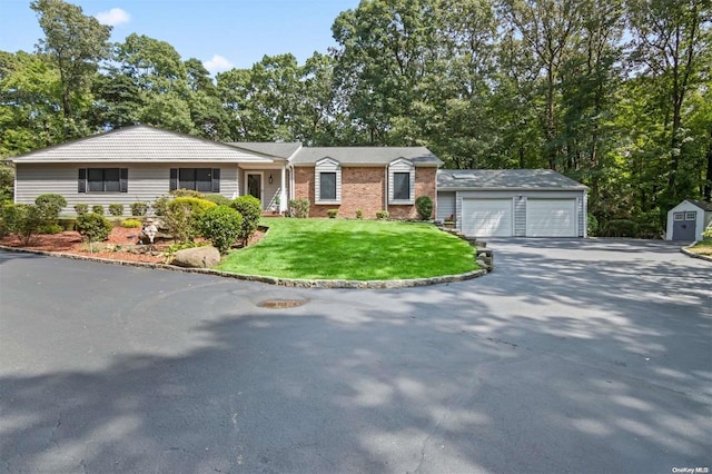 ranch-style home featuring a garage and a front lawn