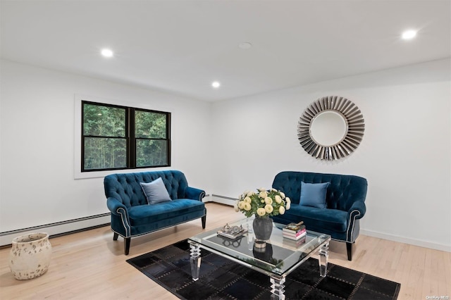 living room with light hardwood / wood-style floors and a baseboard heating unit