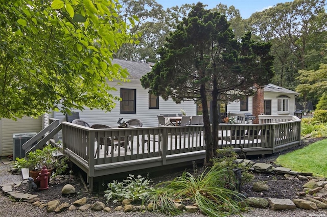 back of house featuring cooling unit and a wooden deck