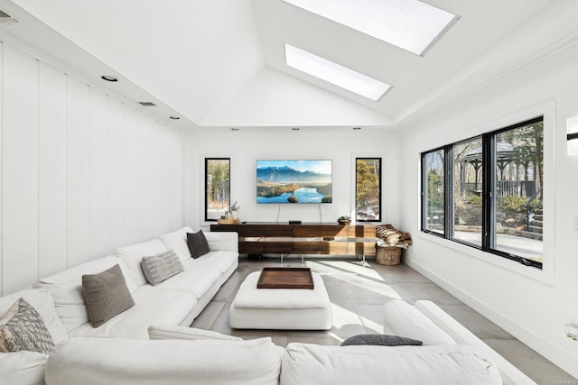 living room with a skylight, visible vents, and high vaulted ceiling