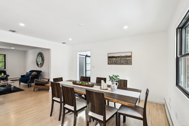 dining space featuring recessed lighting, visible vents, baseboard heating, a barn door, and light wood-style floors