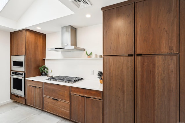 kitchen with open shelves, stainless steel appliances, light countertops, visible vents, and wall chimney exhaust hood