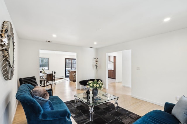 living room featuring recessed lighting, visible vents, light wood-style flooring, and baseboards