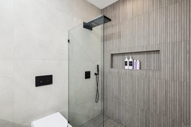 full bathroom with toilet and tiled shower