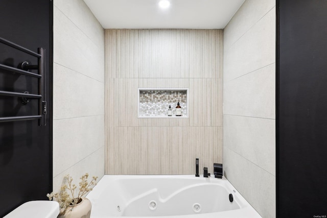 bathroom featuring a whirlpool tub and toilet