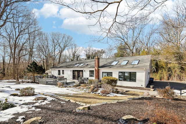 view of front facade featuring a deck and a chimney