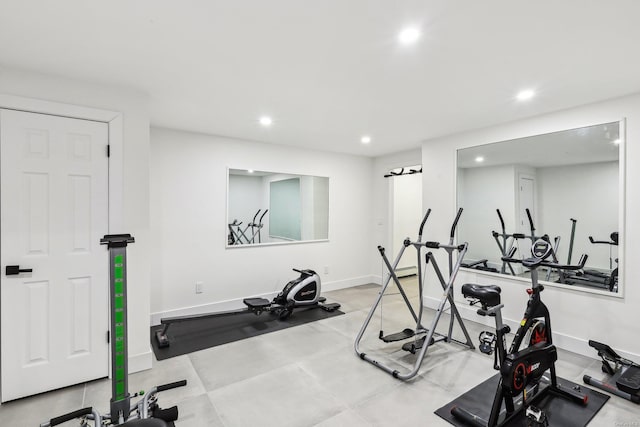 exercise area featuring baseboards and recessed lighting