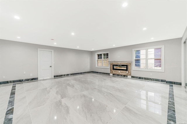 22 Solar Ln, Searingtown, NY 11507 - unfurnished living room featuring recessed lighting, a glass covered fireplace, and baseboards
