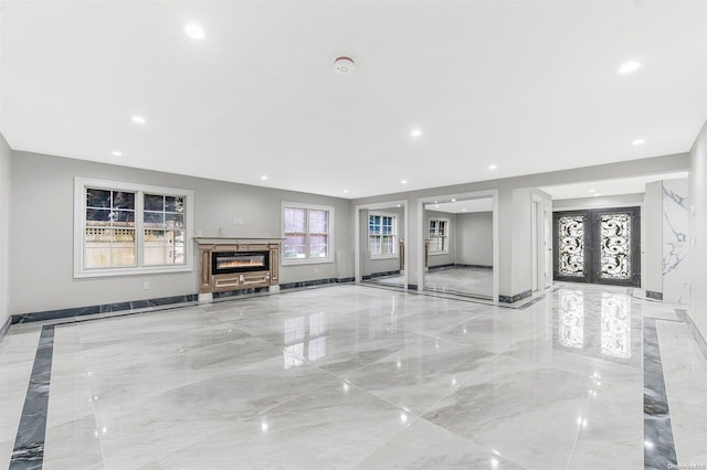 22 Solar Ln, Searingtown, NY 11507 - unfurnished living room with light marble finish flooring, french doors, recessed lighting, and baseboards