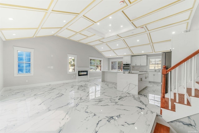 22 Solar Ln, Searingtown, NY 11507 - unfurnished living room featuring plenty of natural light, vaulted ceiling, recessed lighting, stairs, and baseboards