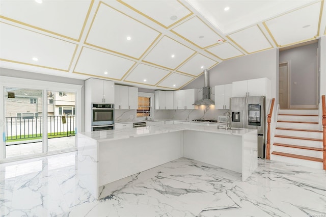 kitchen with sink, white cabinetry, stainless steel appliances, and a large island with sink