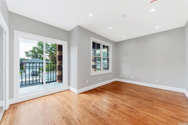 unfurnished room featuring a healthy amount of sunlight and light hardwood / wood-style floors