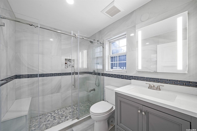 22 Solar Ln, Searingtown, NY 11507 - full bathroom featuring toilet, a shower stall, vanity, tile walls, and decorative backsplash
