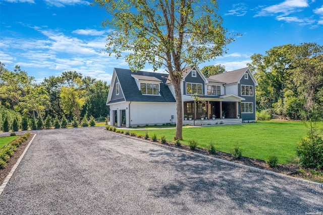 2060 Shipyard Ln, East Marion, NY 11939 - view of front of house with a front lawn and covered porch