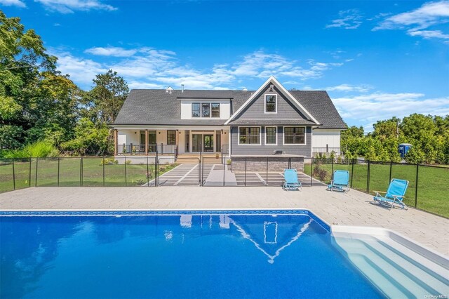 2060 Shipyard Ln, East Marion, NY 11939 - back of property featuring a patio and a shingled roof