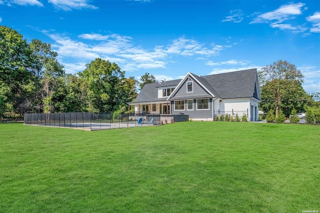 back of property featuring a pool, a patio area, and a lawn