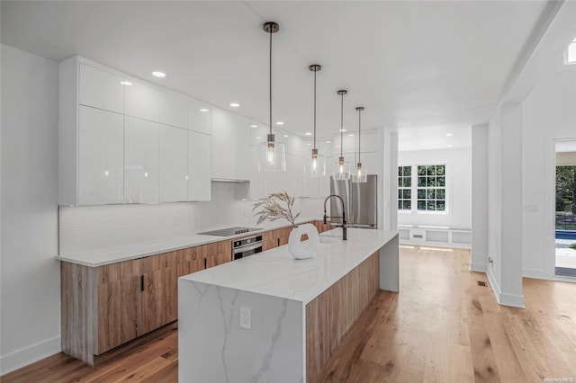 2060 Shipyard Ln, East Marion, NY 11939 - kitchen with modern cabinets, oven, backsplash, white cabinets, and recessed lighting