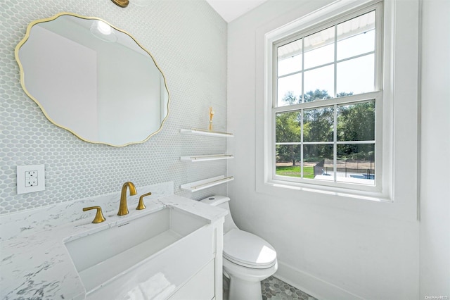 2060 Shipyard Ln, East Marion, NY 11939 - bathroom with plenty of natural light, vanity, toilet, and baseboards