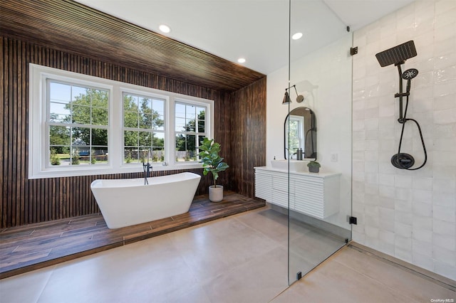 bathroom featuring vanity and plus walk in shower