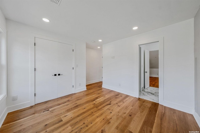 2060 Shipyard Ln, East Marion, NY 11939 - unfurnished bedroom with light wood finished floors, a closet, recessed lighting, baseboards, and ensuite bath