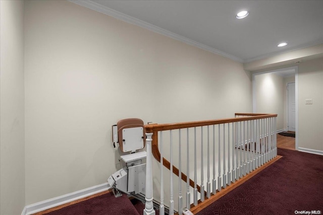 hall with dark carpet and ornamental molding