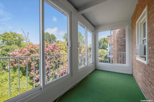 unfurnished sunroom featuring a healthy amount of sunlight and cooling unit