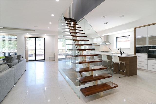 stairway featuring tile patterned flooring