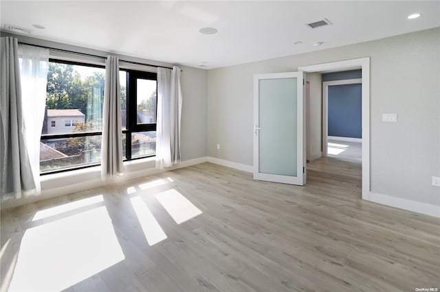 spare room with light hardwood / wood-style floors