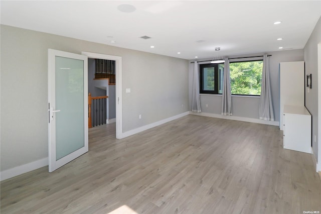 spare room with light wood-type flooring