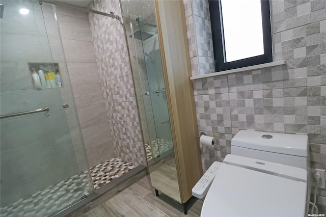 bathroom with a shower with shower door and tile walls