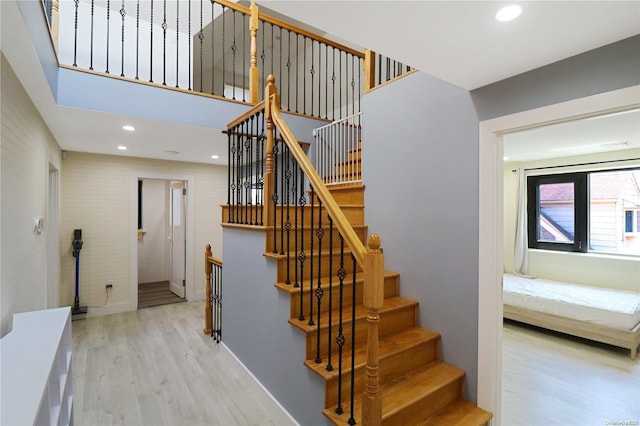 staircase with hardwood / wood-style floors